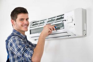 ac technician repairing air conditioner